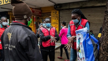 A member of Kenya Red Cross demonstrates hand-washing in Nairobi, Kenya