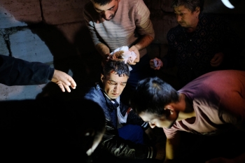 People tending to an injured man during shelling in Stepanakert on 4 October