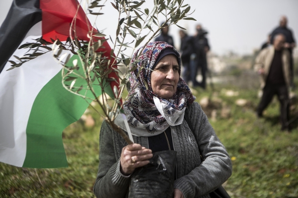 A woman holding a Palestinian flag