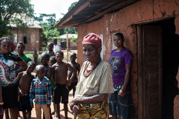 An elderly woman outside her house in Nimbo, Nigeria, after an attack by an AOG