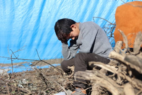 A young syrian boy in a refugee camp 