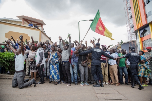 Cameroonians raising their national flag 