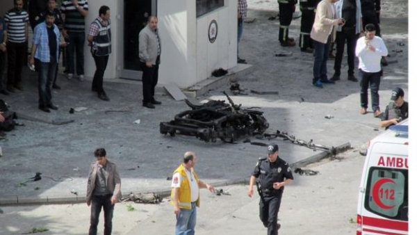 Pieces of a wrecked vehicle could be seen near the gates of a police HQ in Gaziantep 