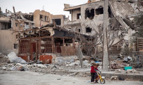 Children play among ruins in Raqqa