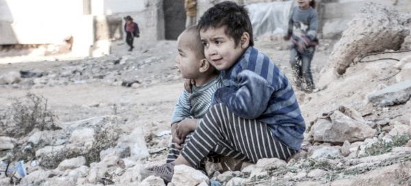 Two children near a shelter for internally displaced people in Aleppo