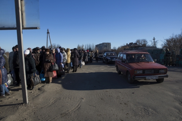Civilians standing in the queue on a cold, winter day  