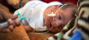 A baby in the nursery at Alsadaqah Hospital, Yemen.