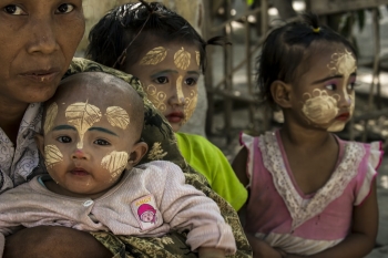 Children with leaves made of thanaka painted on their faces