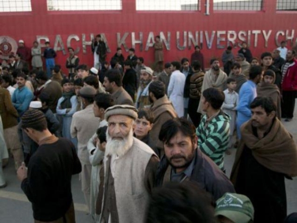 Family members of students stand outside the Bacha Khan University in Charsadda town, 35 km outside the city of Peshawar
