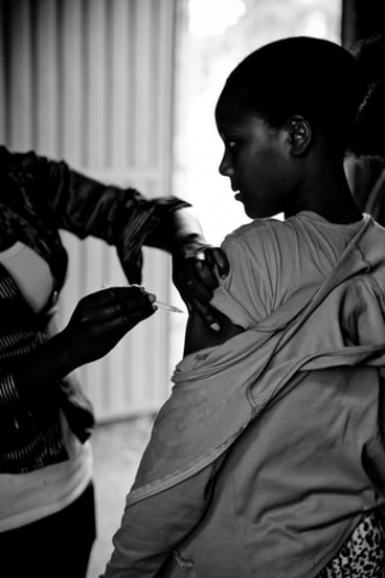 A girl receiving a vaccine in an Ethiopian hospital