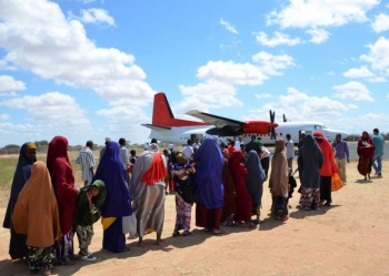 Somali refugees board a plane that will take them home to Mogadishu from Dadaab camp in Kenya.  