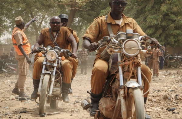 Burkinabe volunteer fighters driving their motorbikes