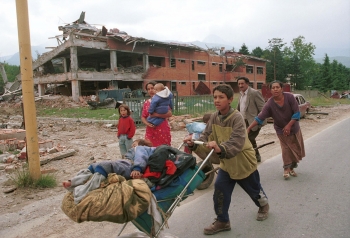 Kosovo civilians fleeing their home, Kosovo Polje, June 1999