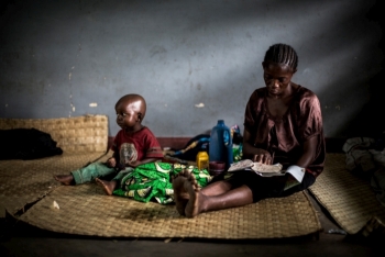 A woman who fled the village of Banda in Kasai Province with her child