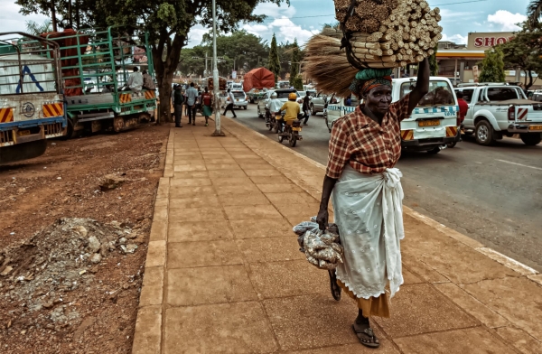 A woman carrying goods in a village in the Democratic Republic of Congo