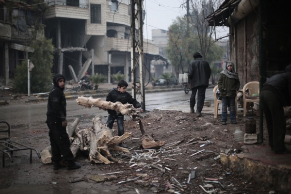Two boys collect tree branches to make fire wood in Kafar Batna village in Rural Damascus, Syria. 