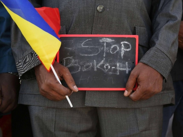 Un uomo regge una tavoletta su cui si legge &quot;Stop Boko Haram&quot; durante una manifestazione di supporto alle truppe ciadiane in marcia verso il Camerun per combattere Boko Haram, Ndjamena, 17 gennaio 2015.