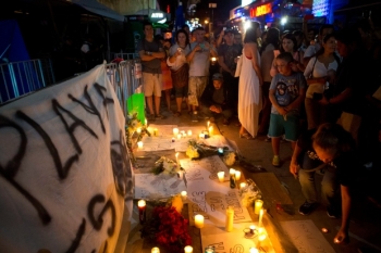 Local residents placing candles outside the club where many people were killed in Playa del Carmen, Mexico. 