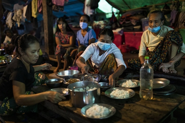Women preparing dinner in a displaced people camp in Mrauk U, Myanmar, August 2020