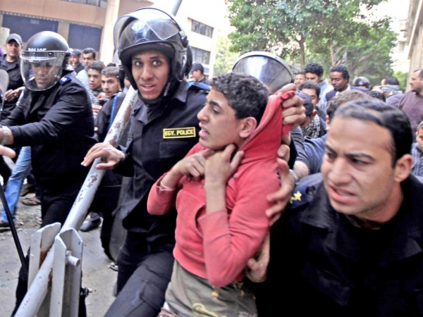 Young man arrested by Egyptian police during a protest in Cairo