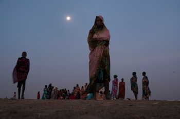 Donne in attesa ad una stazione di raccolta dell’acqua in un campo per sfollati a Bentiu 