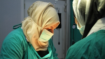 Healthcare women workers performs a surgery in Syria