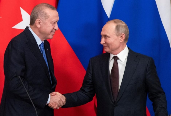 Turkish and Russian leader shake hands in Moscow after announcing new ceasefire in Idlib
