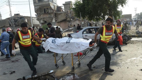 Rescue workers move the body of a victim of the explosion.