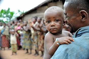 A child in a man&#039;s arms in the Central African Republic. 