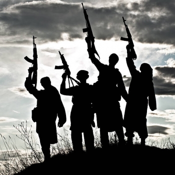Silhouette of muslim militants with rifles 