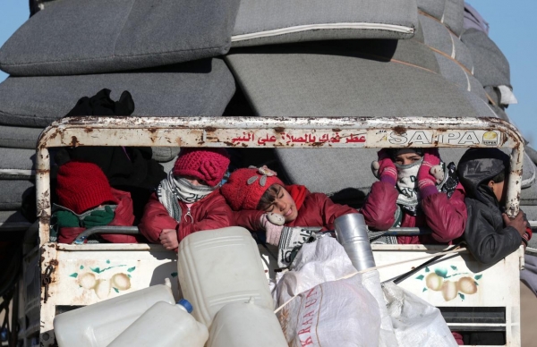 Syrian children fleeing Idlib ride on the back of a truck in Azaz, Syria, 24 January 2020. 