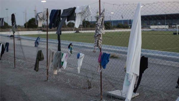  Clothes hanging on barbed wire fence at the Elliniko refugee camp 