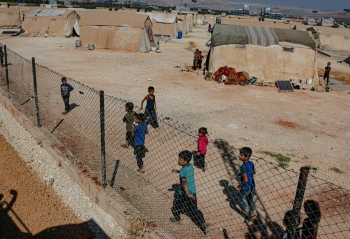 Children walking in a refugee camp