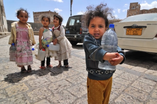 Children with empty water-bottles in Sanaʽa, Yemen.